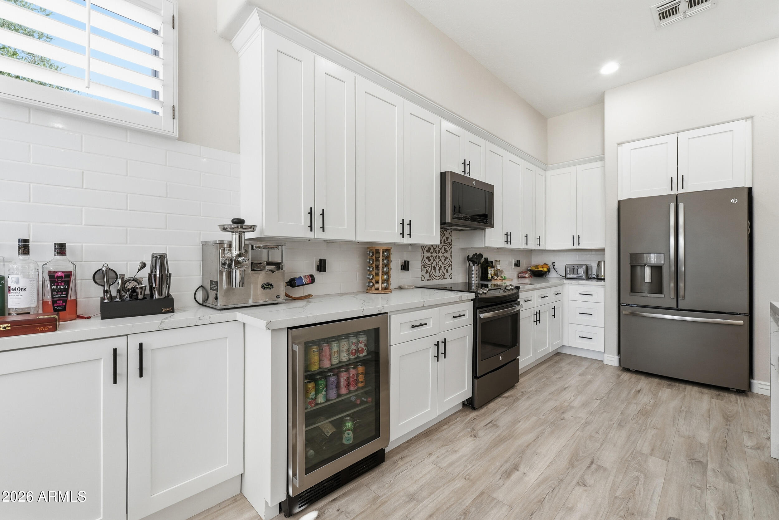 2633 East Fremont Road Phoenix, AZ 85042 - Photo 16 of 43 a kitchen with cabinets stainless steel appliances and wooden floor