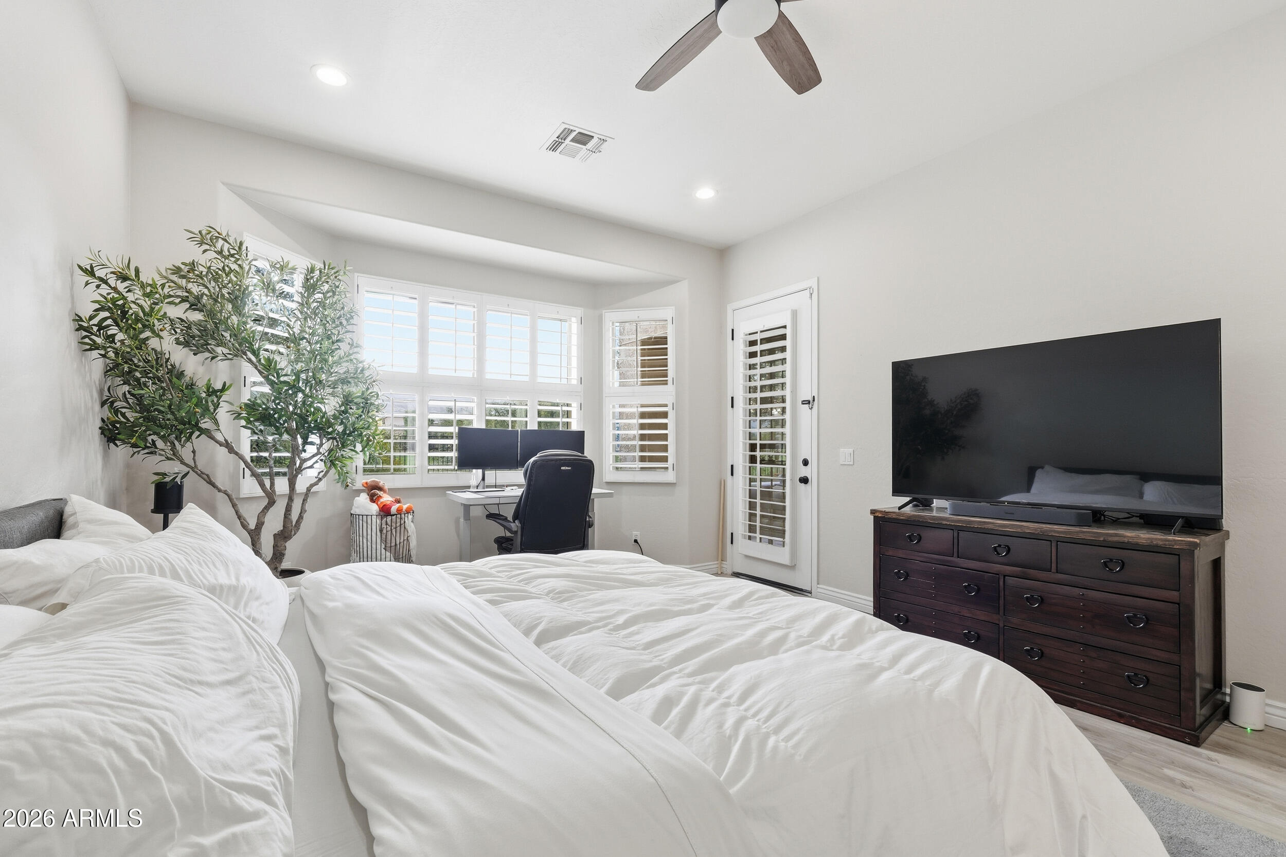 2633 East Fremont Road Phoenix, AZ 85042 - Photo 19 of 43 a bedroom with a bed and a flat screen tv