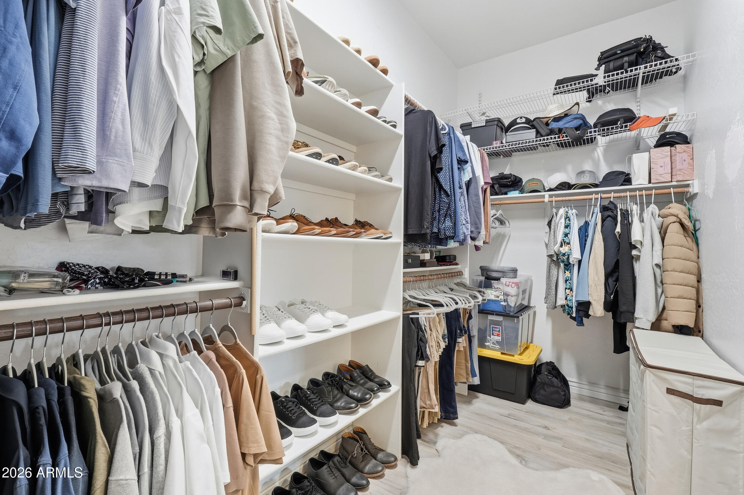 2633 East Fremont Road Phoenix, AZ 85042 - Photo 26 of 43 a view of walk in closet with clothes and shoes