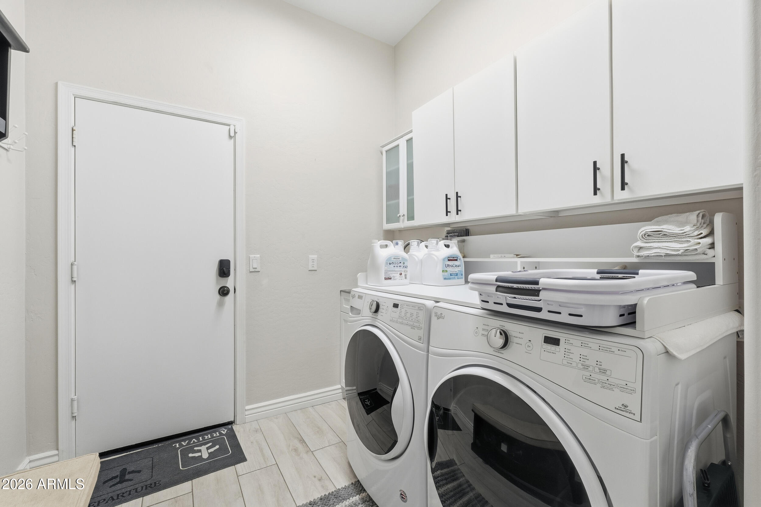 2633 East Fremont Road Phoenix, AZ 85042 - Photo 33 of 43 a view of washer and dryer with kitchen in the background