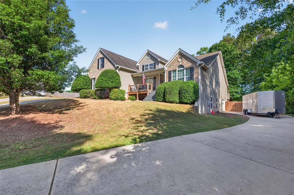 89 Katie Spring Lane Jefferson, GA 30549 - Photo 4 of 63 a front view of a house with a yard and garage