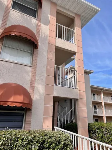a view of a house with a door and a car parked
