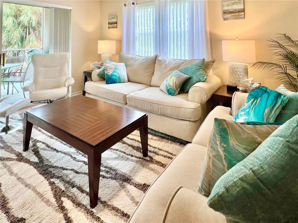 6501 Stone River Road, Unit 203 Bradenton, FL 34203 - Photo 19 of 45 a living room with furniture and a table