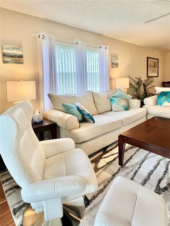 6501 Stone River Road, Unit 203 Bradenton, FL 34203 - Photo 21 of 45 a living room with furniture and a large window