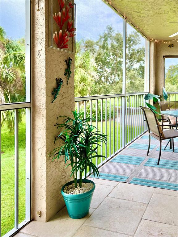 6501 Stone River Road, Unit 203 Bradenton, FL 34203 - Photo 23 of 45 a view of a porch with furniture and garden
