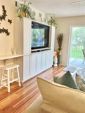 a living room with a couch swing table and chairs