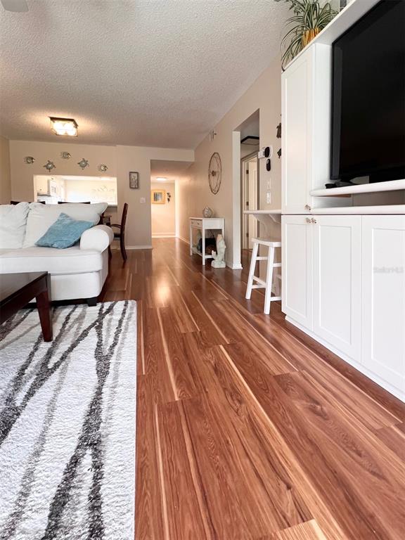 6501 Stone River Road, Unit 203 Bradenton, FL 34203 - Photo 8 of 45 a living room with furniture and a flat screen tv