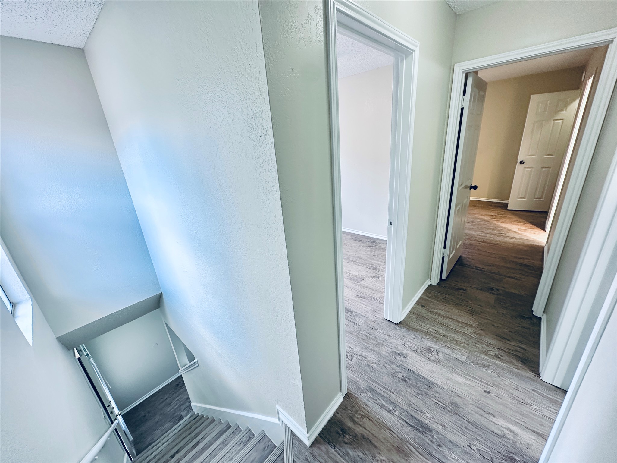 379 Fantail Loop, Unit B Austin, TX 78734 - Photo 18 of 33 Smooth wood-look flooring flows throughout the hallway and adjoining upper-level rooms.