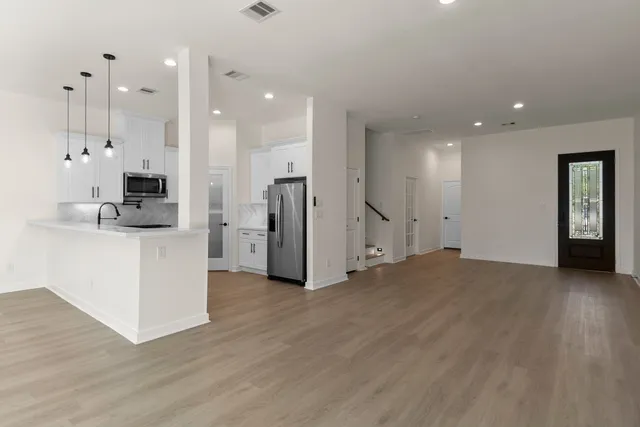a view of entryway and hall with wooden floor