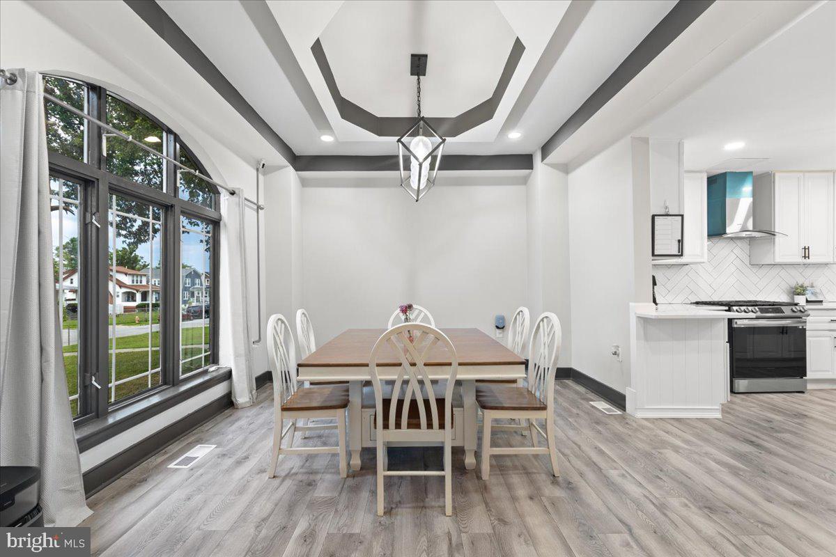 3910 Chatham Road Baltimore, MD 21207 - Photo 13 of 71 a view of a dining room with furniture window and wooden floor