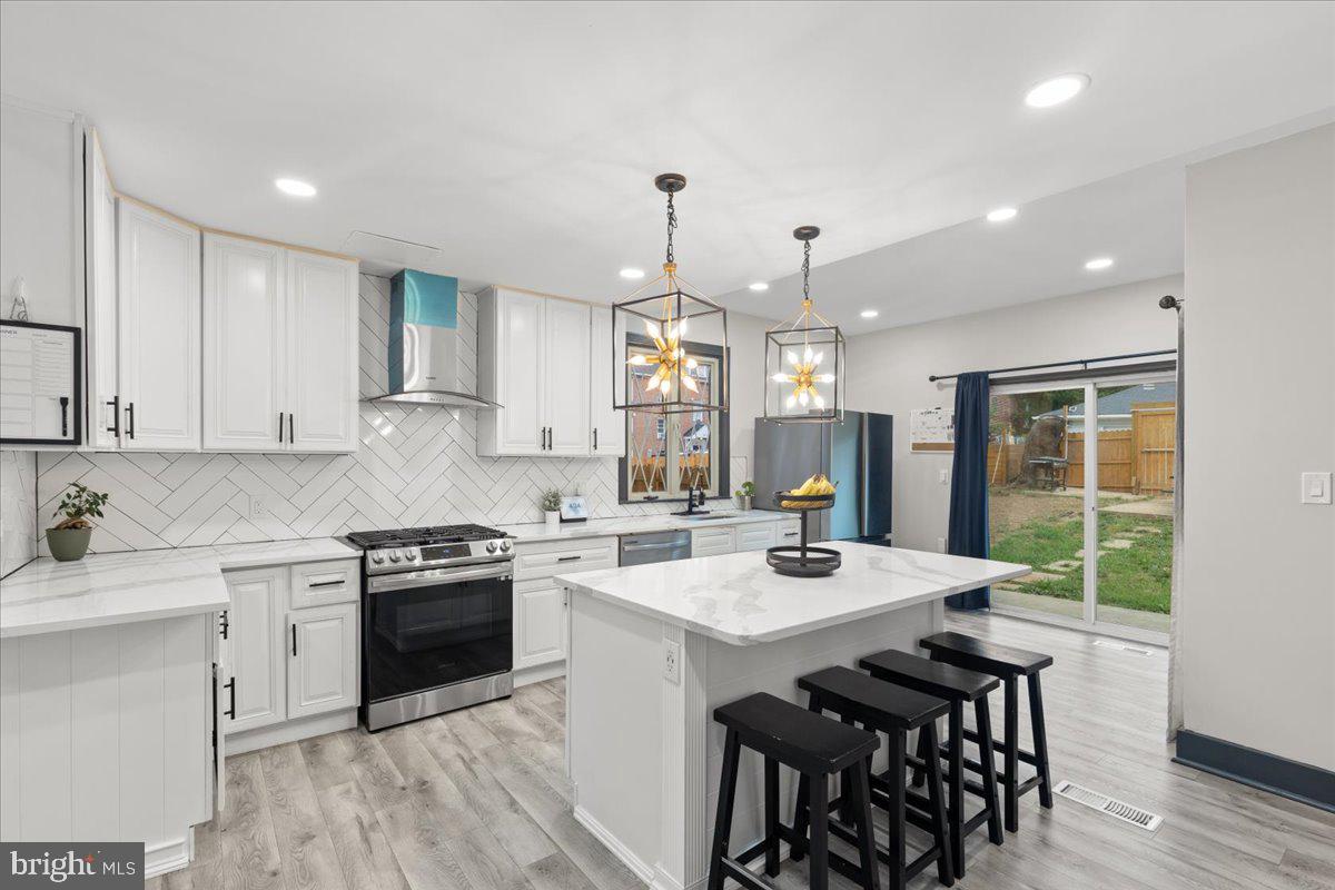 3910 Chatham Road Baltimore, MD 21207 - Photo 14 of 71 a kitchen with a stove a sink and a refrigerator