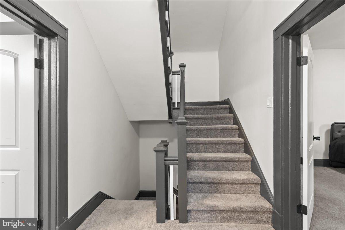 3910 Chatham Road Baltimore, MD 21207 - Photo 26 of 71 a view of staircase with white walls and railing