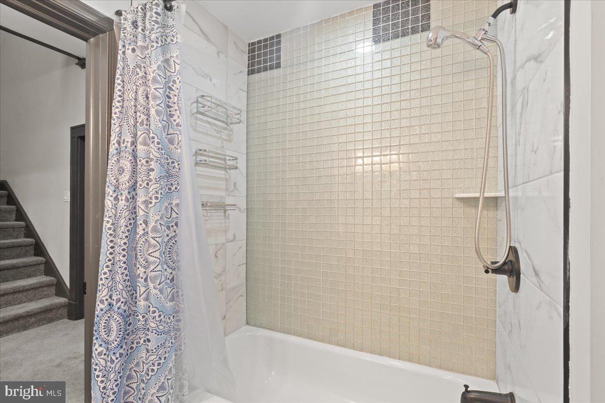 3910 Chatham Road Baltimore, MD 21207 - Photo 34 of 71 a bathroom with a shower and a bathtub
