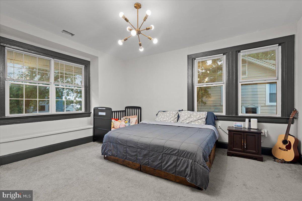 3910 Chatham Road Baltimore, MD 21207 - Photo 36 of 71 a bedroom with a bed and a large window