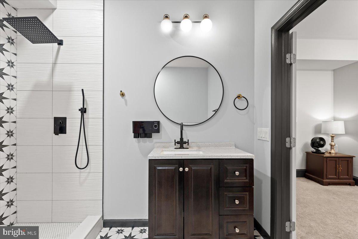 3910 Chatham Road Baltimore, MD 21207 - Photo 40 of 71 a bathroom with a sink vanity and a mirror