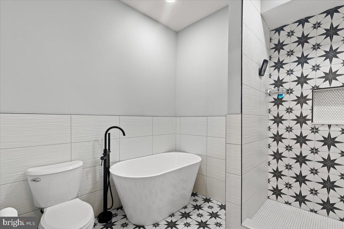 3910 Chatham Road Baltimore, MD 21207 - Photo 42 of 71 a bathroom with a toilet sink and shower