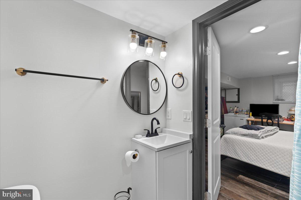 3910 Chatham Road Baltimore, MD 21207 - Photo 57 of 71 a bathroom with a sink and a mirror