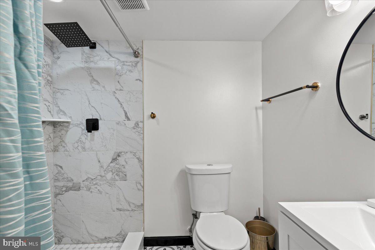 3910 Chatham Road Baltimore, MD 21207 - Photo 58 of 71 a white toilet sitting next to a bathroom sink