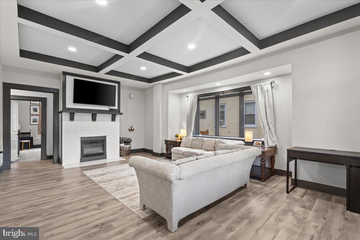 3910 Chatham Road Baltimore, MD 21207 - Photo 8 of 71 a living room with fireplace furniture and a flat screen tv