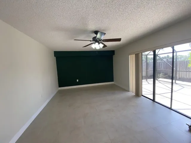 a view of a livingroom with a ceiling fan and window