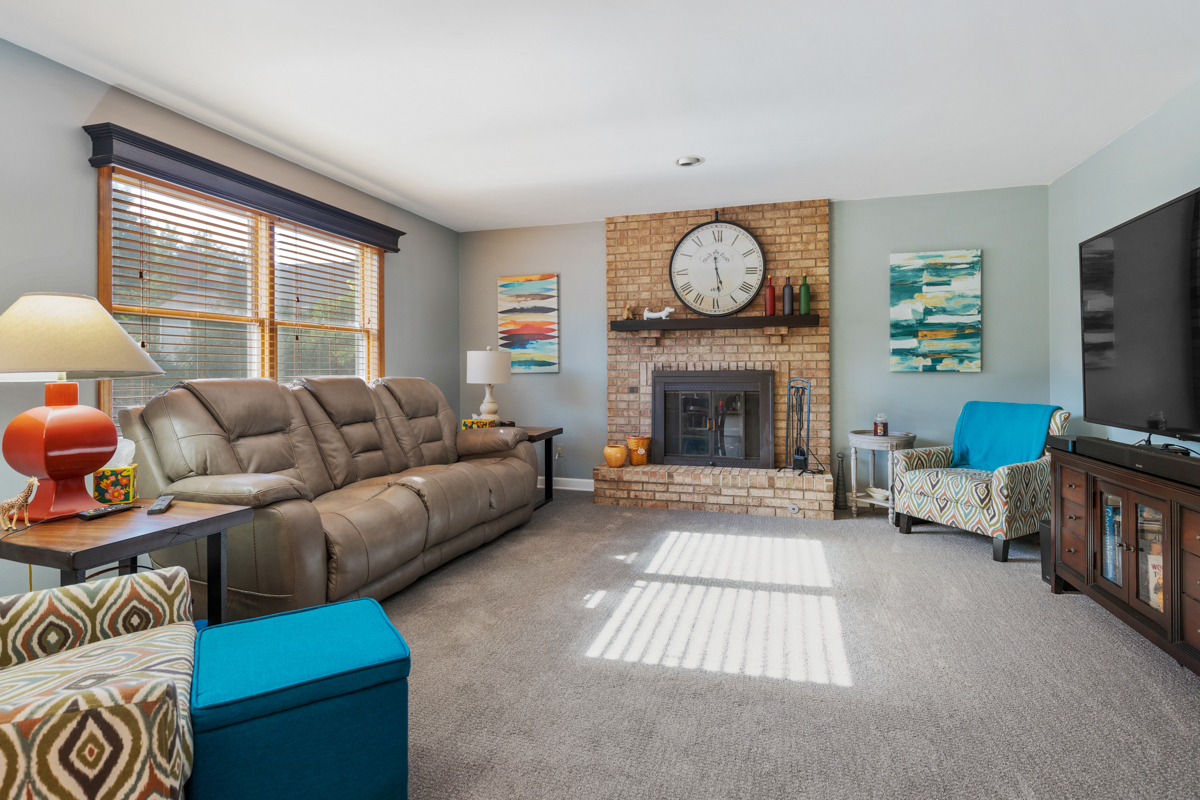 2225 Forest Ridge Road St. Charles, IL 60174 - Photo 11 of 24 a living room with furniture a large window and a fireplace
