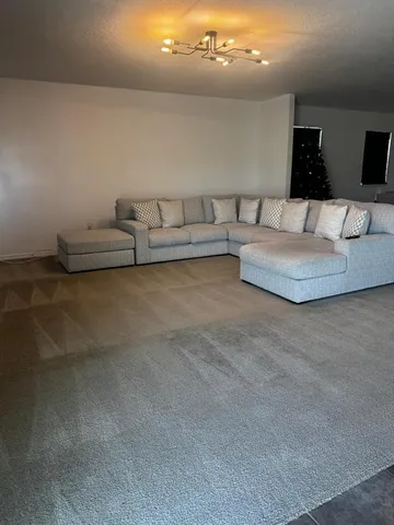 a living room with furniture and a night stand