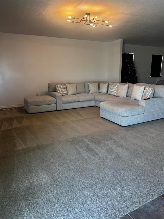 3837 Spring Creek Road Dundee, FL 33838 - Photo 3 of 13 a living room with furniture and a night stand