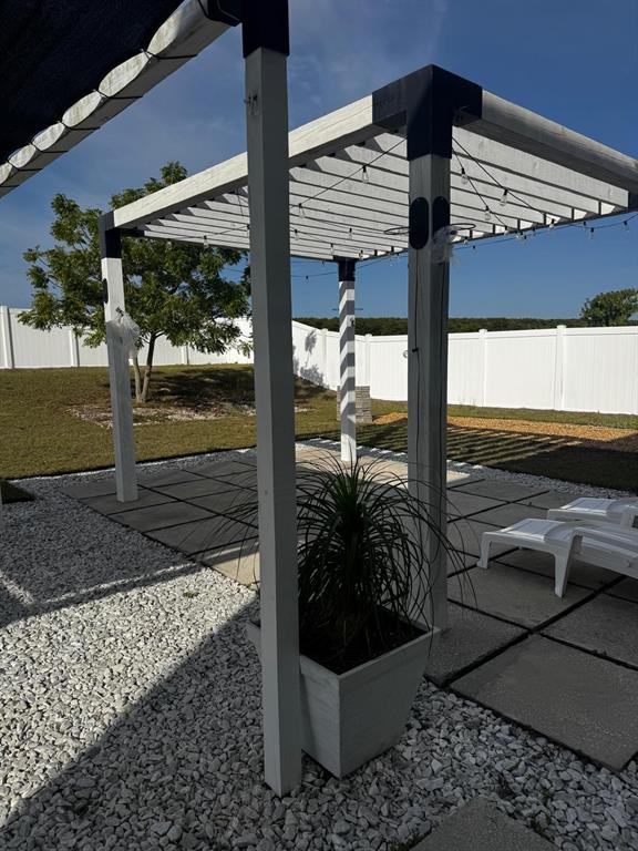 3837 Spring Creek Road Dundee, FL 33838 - Photo 8 of 13 a view of a porch with a sitting table and chairs under an umbrella