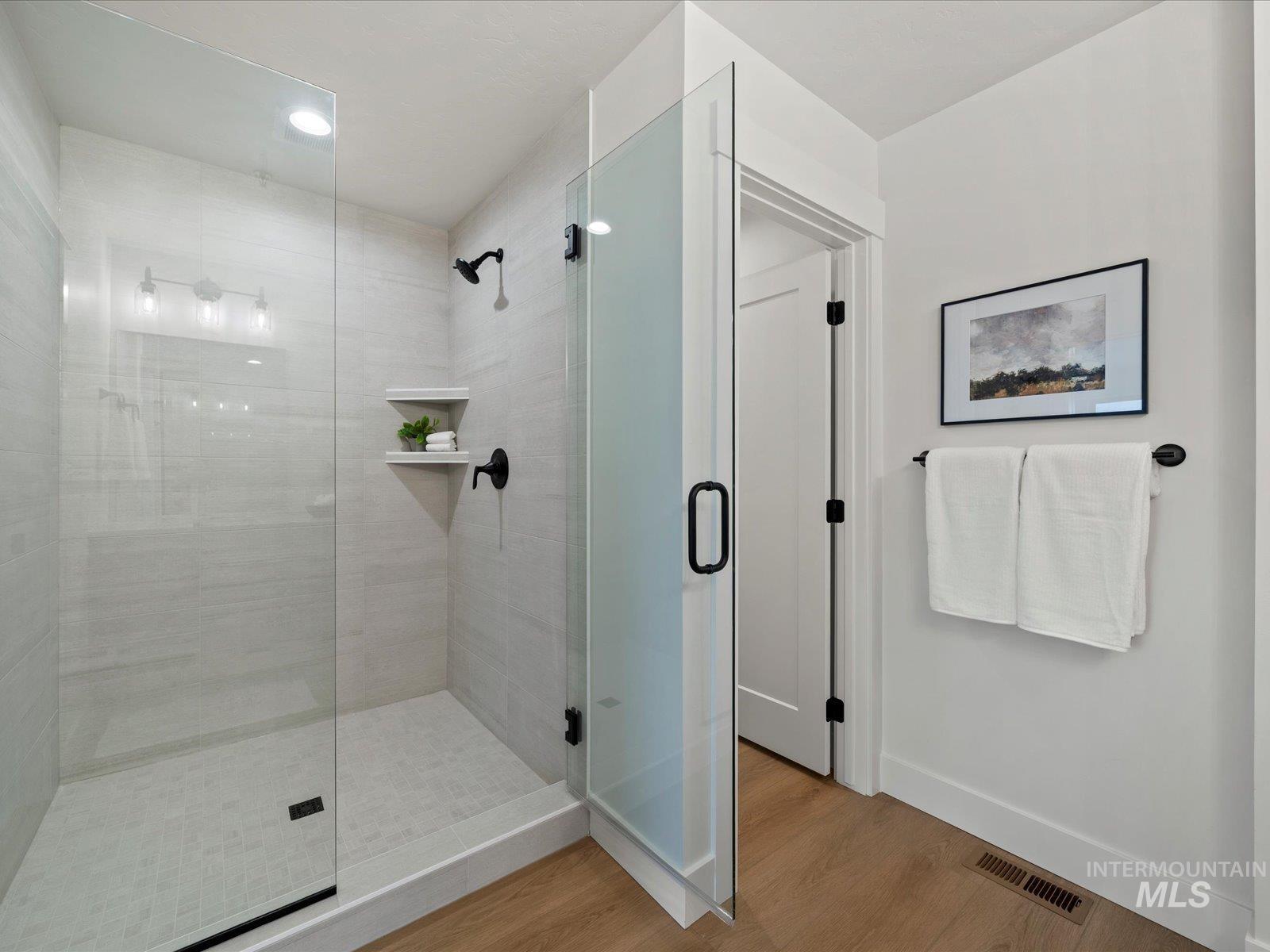 1707 South Federal Way Boise, ID 83705 - Photo 25 of 47 Full bath featuring a stall shower, wood finished floors, and recessed lighting