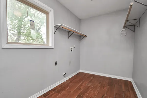 a view of a room with wooden floor and fan