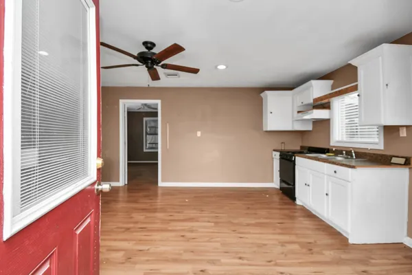 a kitchen with stainless steel appliances granite countertop a sink and cabinets