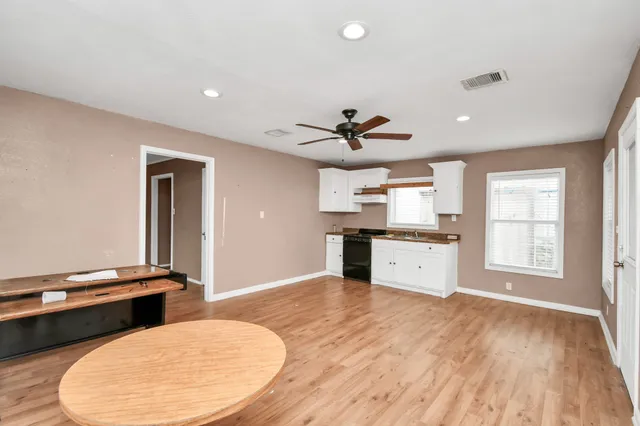 a view of kitchen with windows and ceiling fan