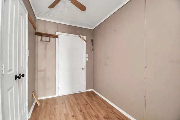 a view of a hallway with wooden floor and closet