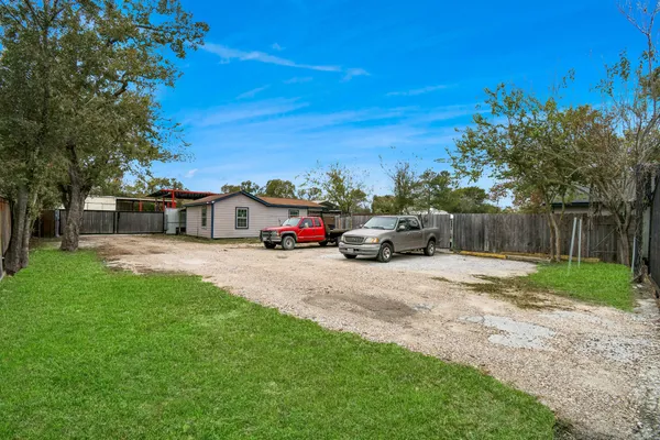 a car parked in front of a house and a yard