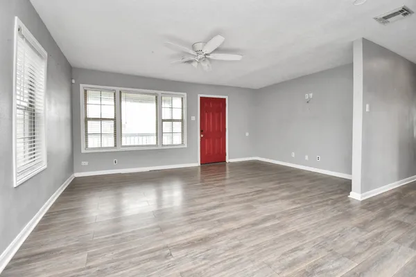 wooden floor in an empty room with a window