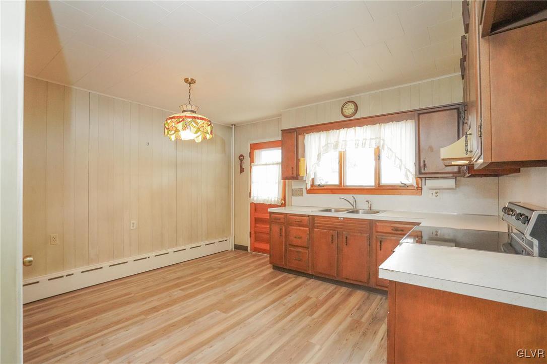 240 West Ridge Street Coaldale, PA 18218 - Photo 17 of 47 a large kitchen with a wooden floor and outdoor space