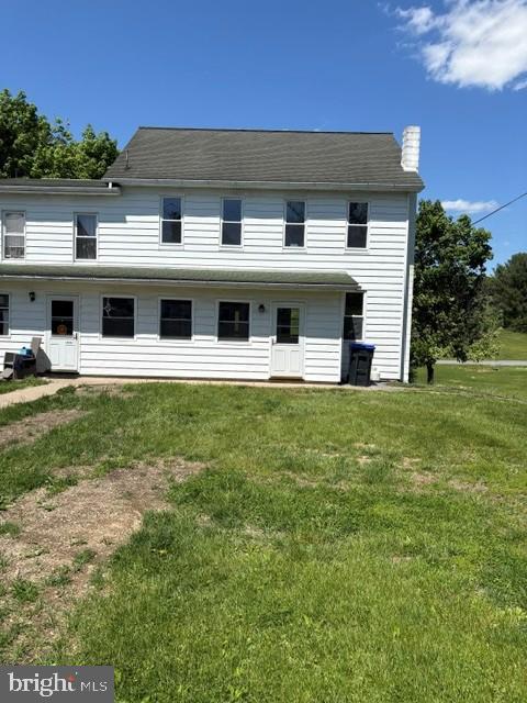 a view of house with yard