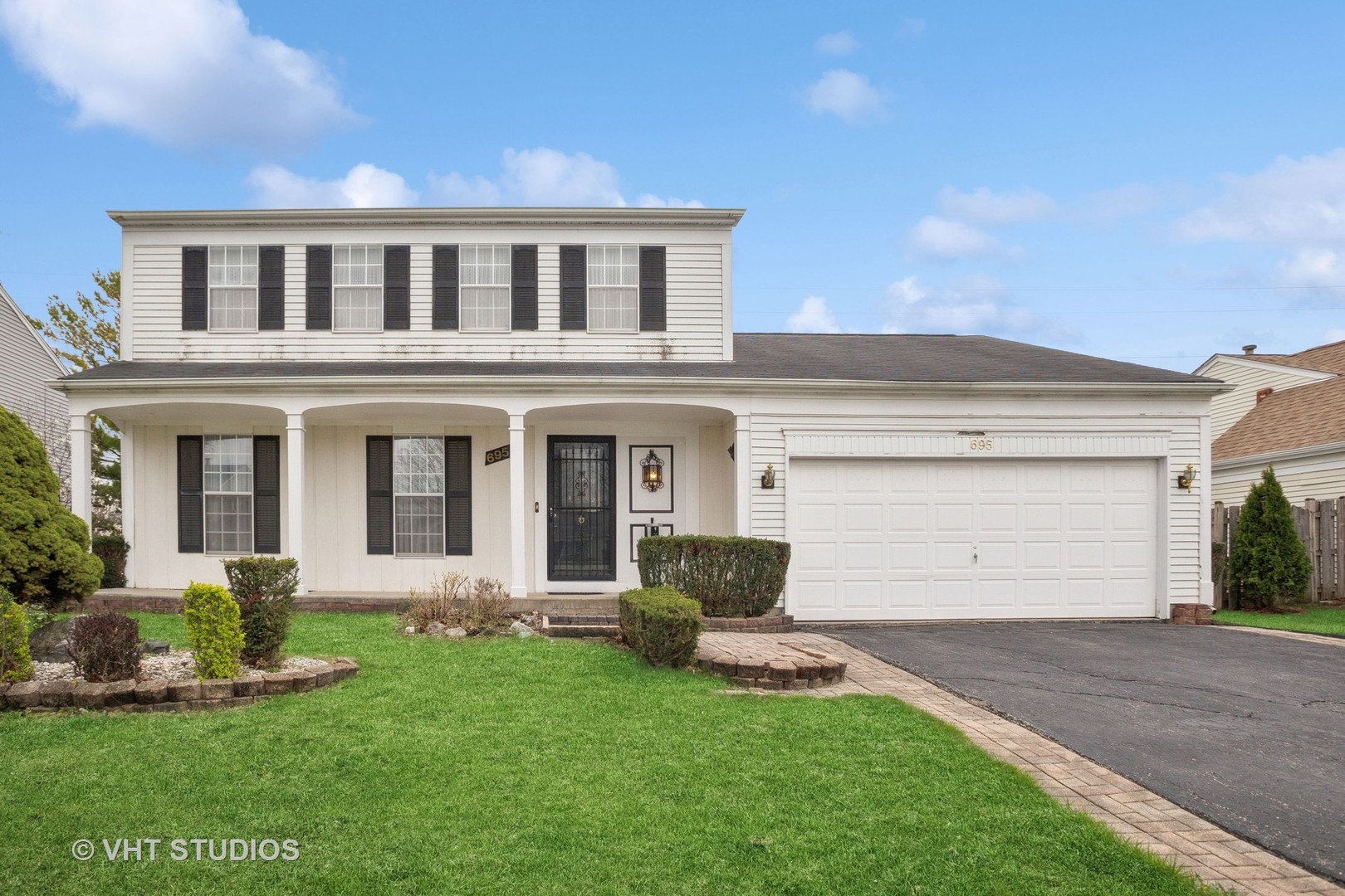 a front view of a house with a yard and garage