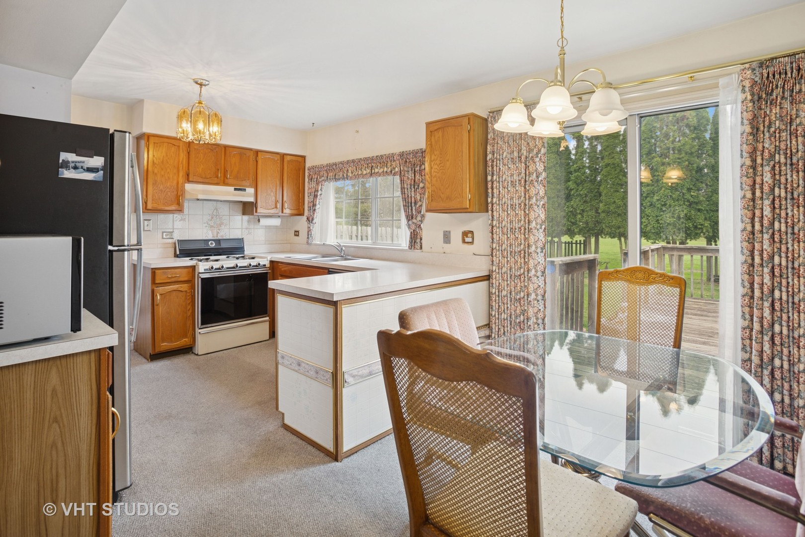 695 West Paddock Drive Wheeling, IL 60090 - Photo 5 of 18 a kitchen that has a lot of cabinets and stainless steel appliances