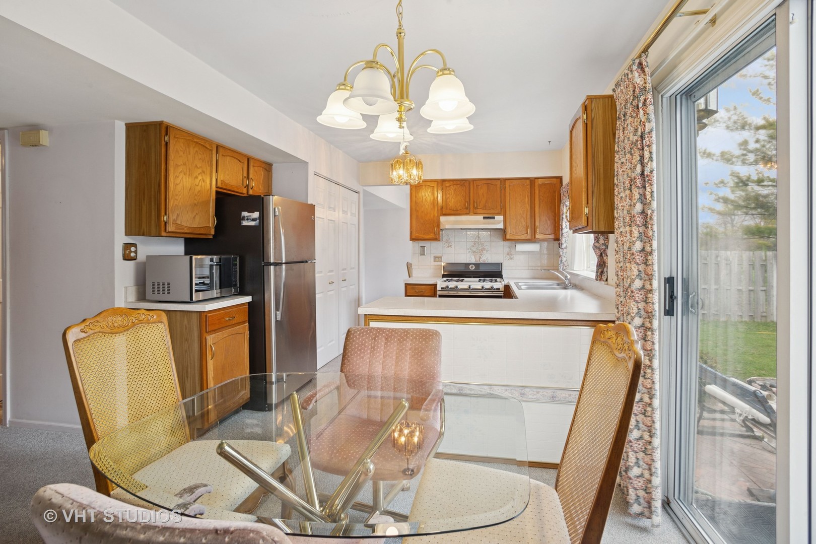 695 West Paddock Drive Wheeling, IL 60090 - Photo 6 of 18 a living room with a fireplace and a chandelier