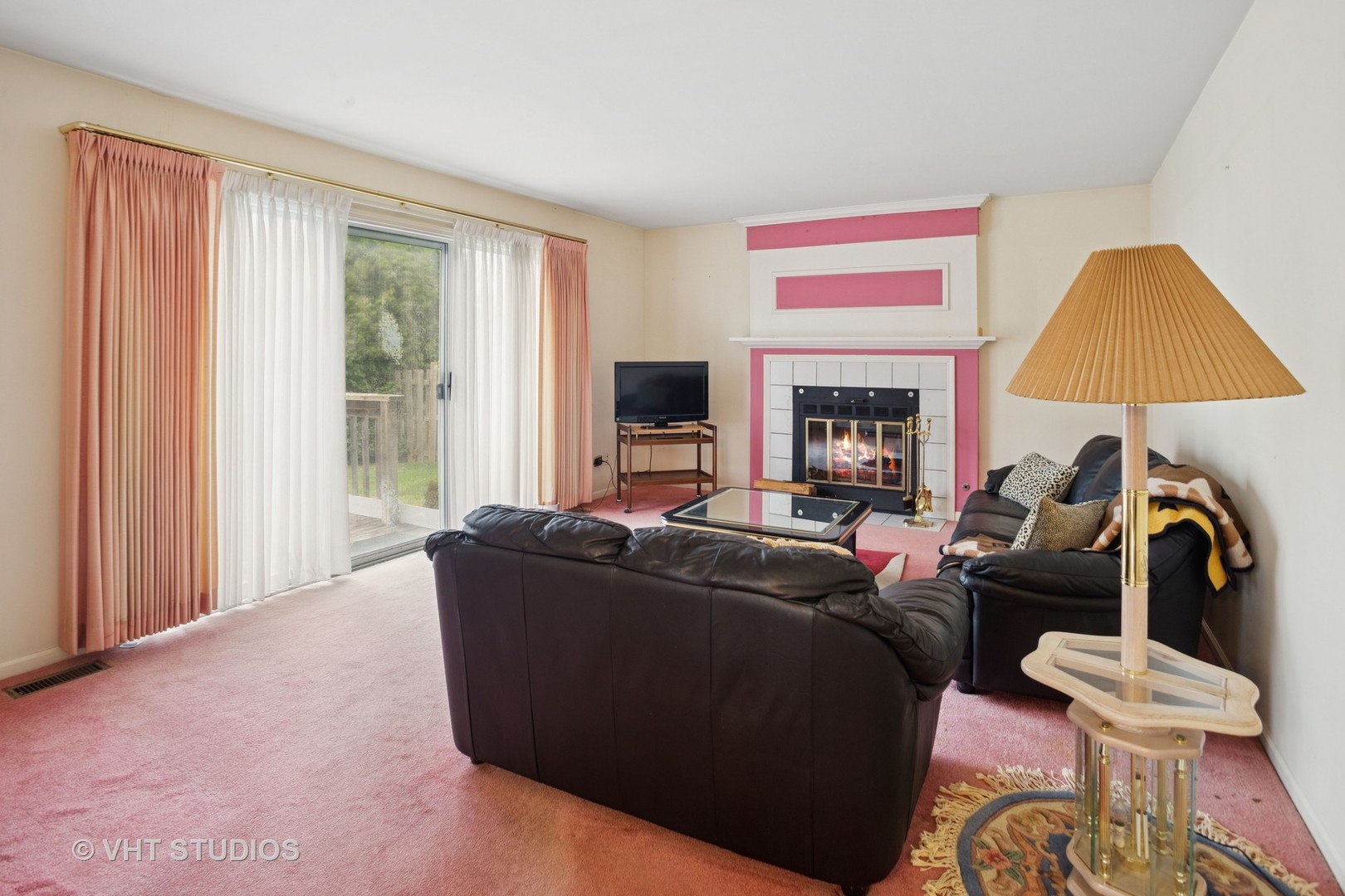 695 West Paddock Drive Wheeling, IL 60090 - Photo 8 of 18 a living room with furniture a fireplace and a flat screen tv