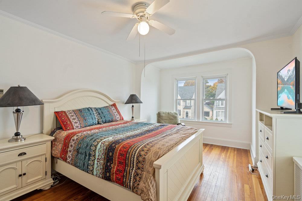 80 Munro Boulevard Valley Stream, NY 11581 - Photo 11 of 28 a bedroom with a bed and a chandelier