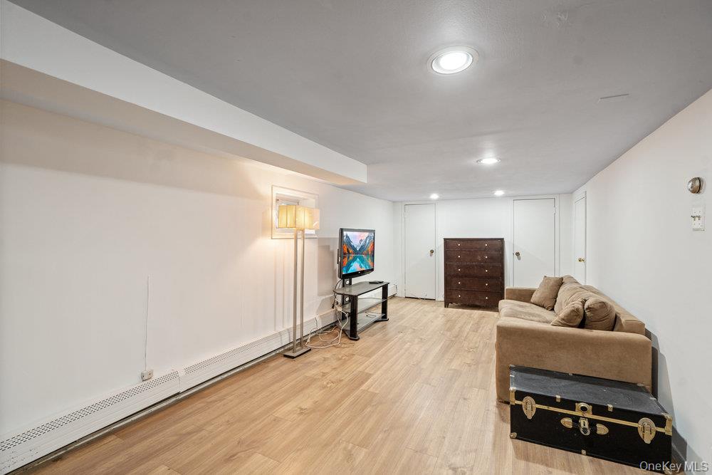 80 Munro Boulevard Valley Stream, NY 11581 - Photo 16 of 28 a living room with furniture and a flat screen tv