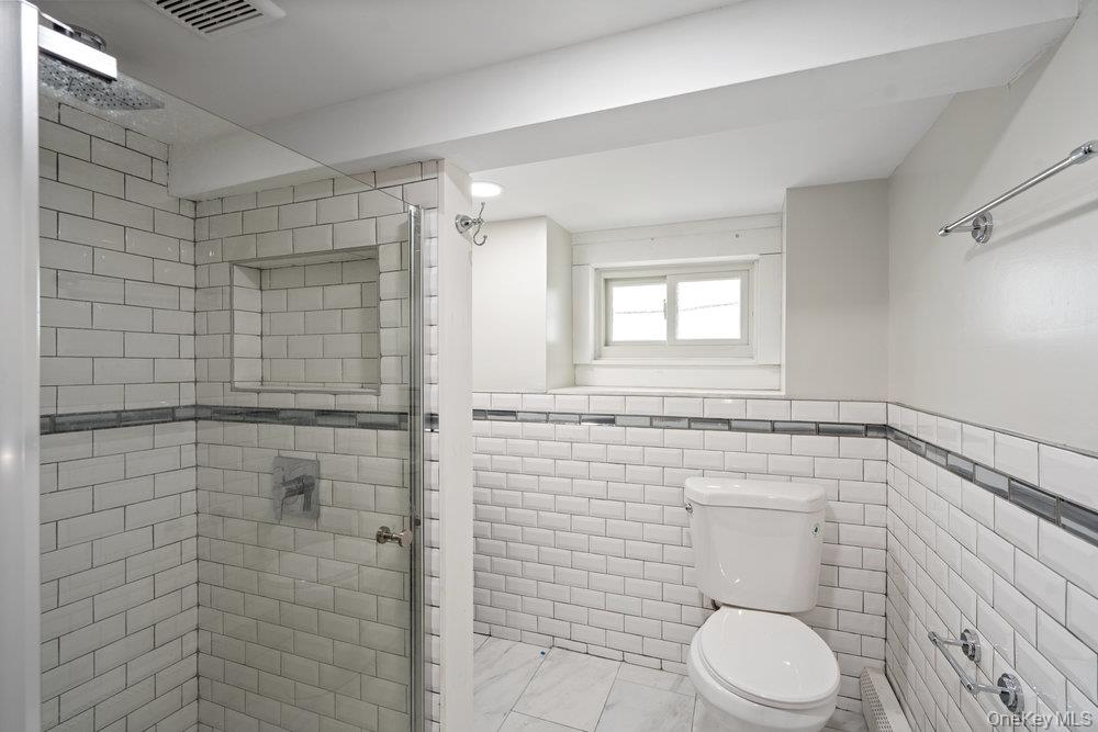 80 Munro Boulevard Valley Stream, NY 11581 - Photo 19 of 28 a bathroom with a toilet and a shower