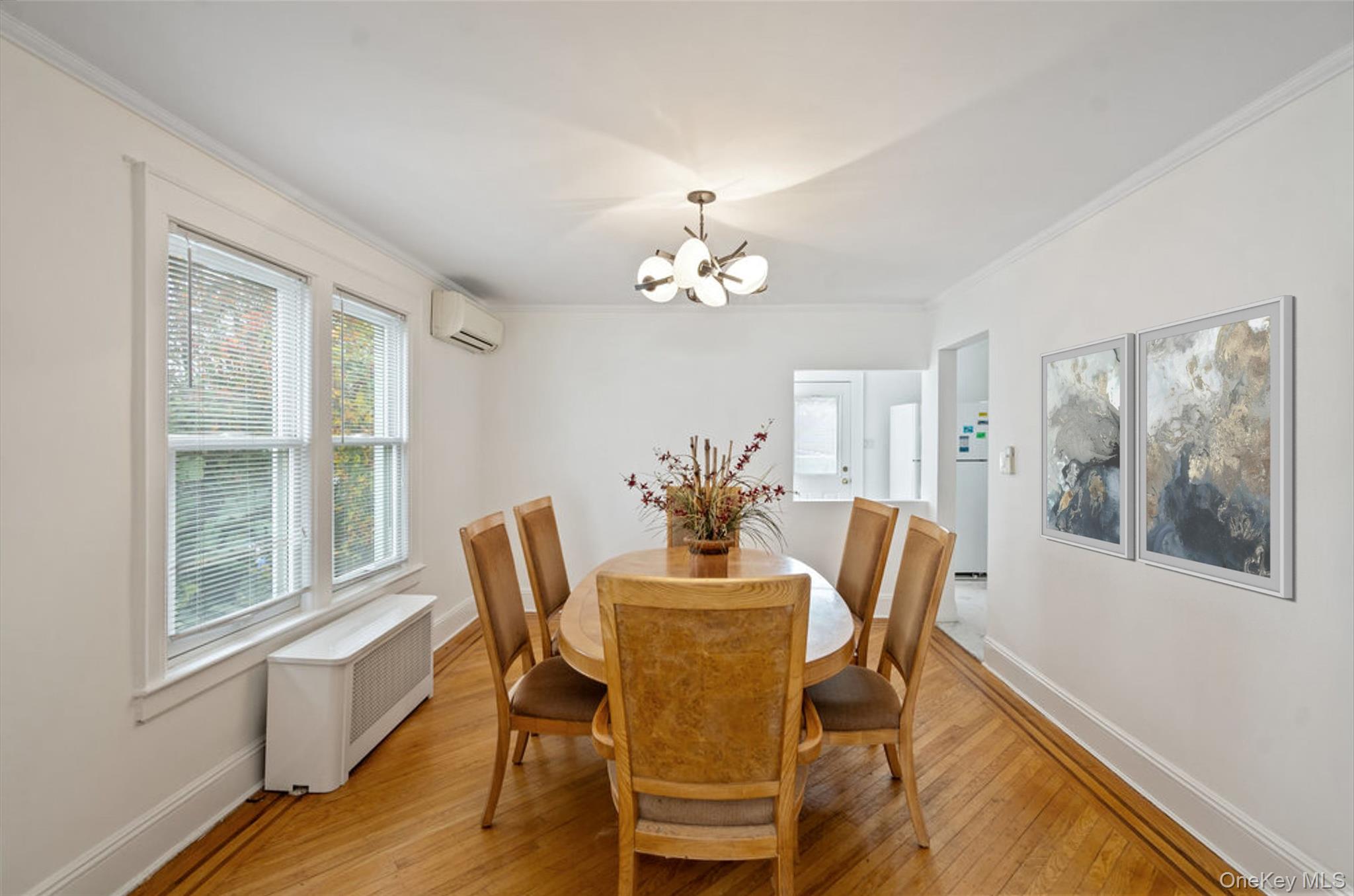 80 Munro Boulevard Valley Stream, NY 11581 - Photo 6 of 28 a dining room with furniture a chandelier and wooden floor