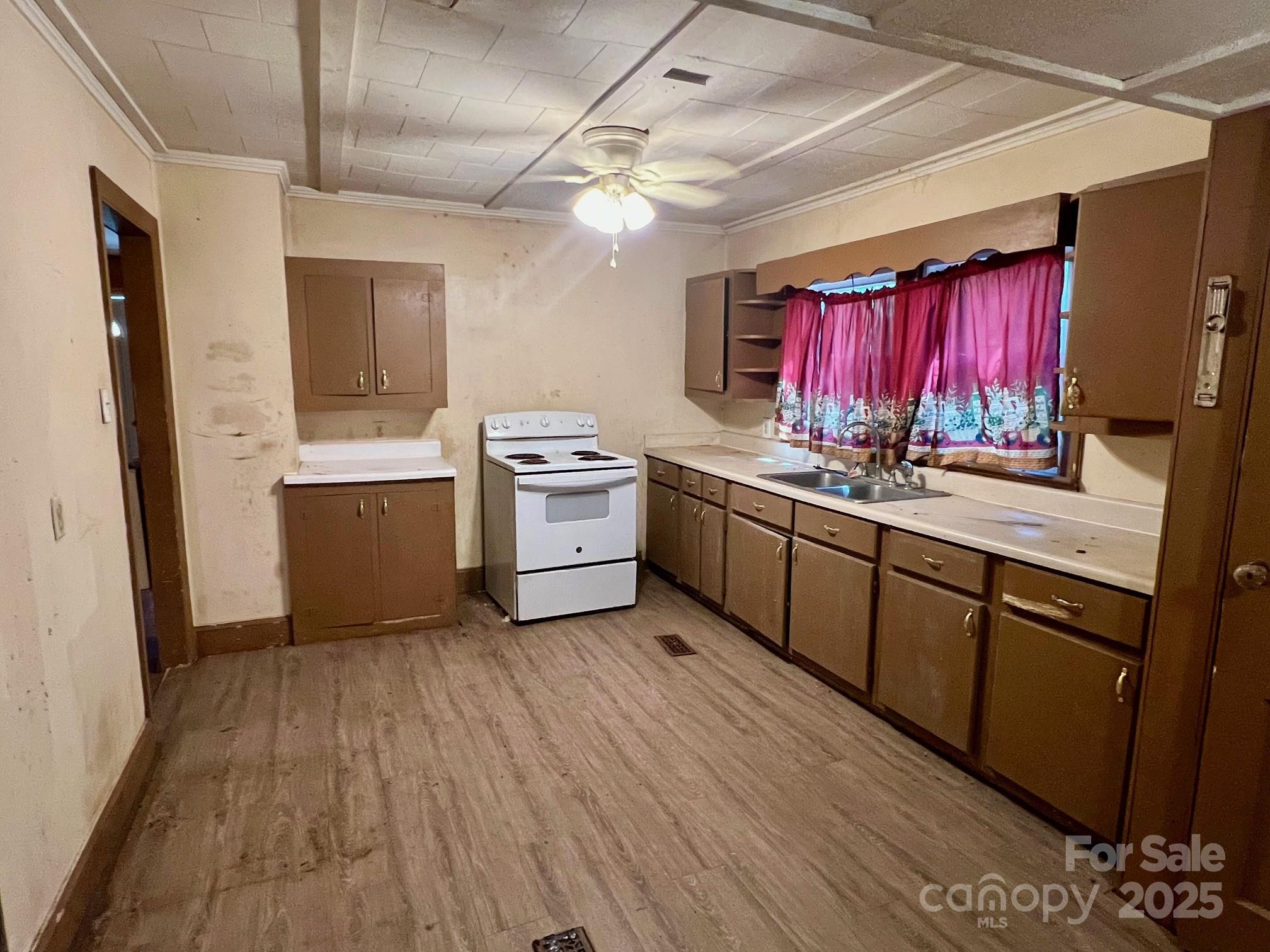 295 D D. Mathis Drive Rutherfordton, NC 28139 - Photo 5 of 11 a kitchen with stainless steel appliances granite countertop a sink dishwasher a stove a refrigerator with wooden cabinets and floor