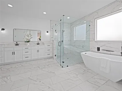 a bathroom with a granite countertop sink a toilet and bathtub