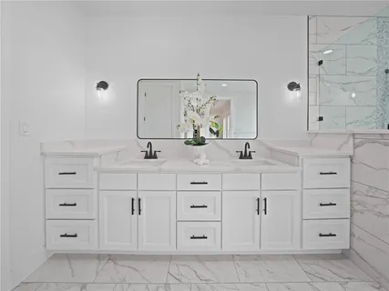 a bathroom with a sink vanity and mirror
