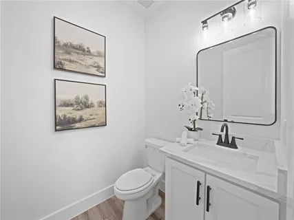 a bathroom with a toilet sink and mirror