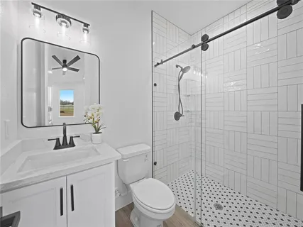 a bathroom with a sink toilet and shower
